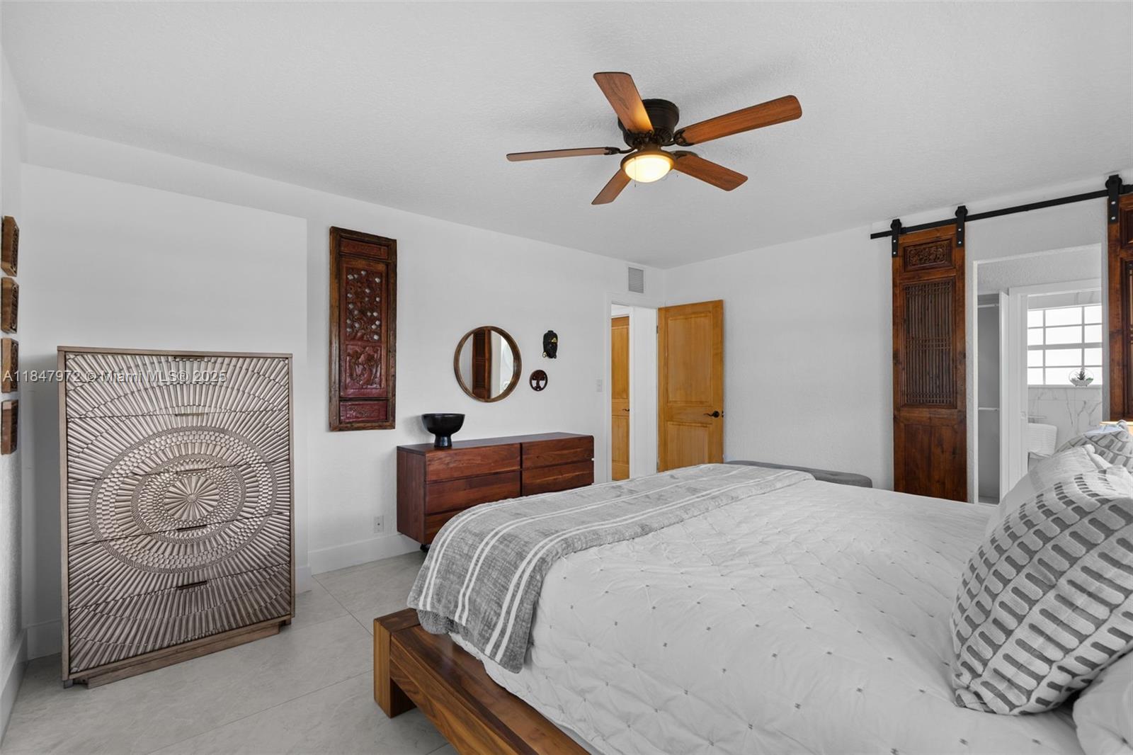 2681 Northeast 9th Court Pompano Beach, FL 33062 - Photo 22 of 58 a bedroom with a bed and a painting on the wall