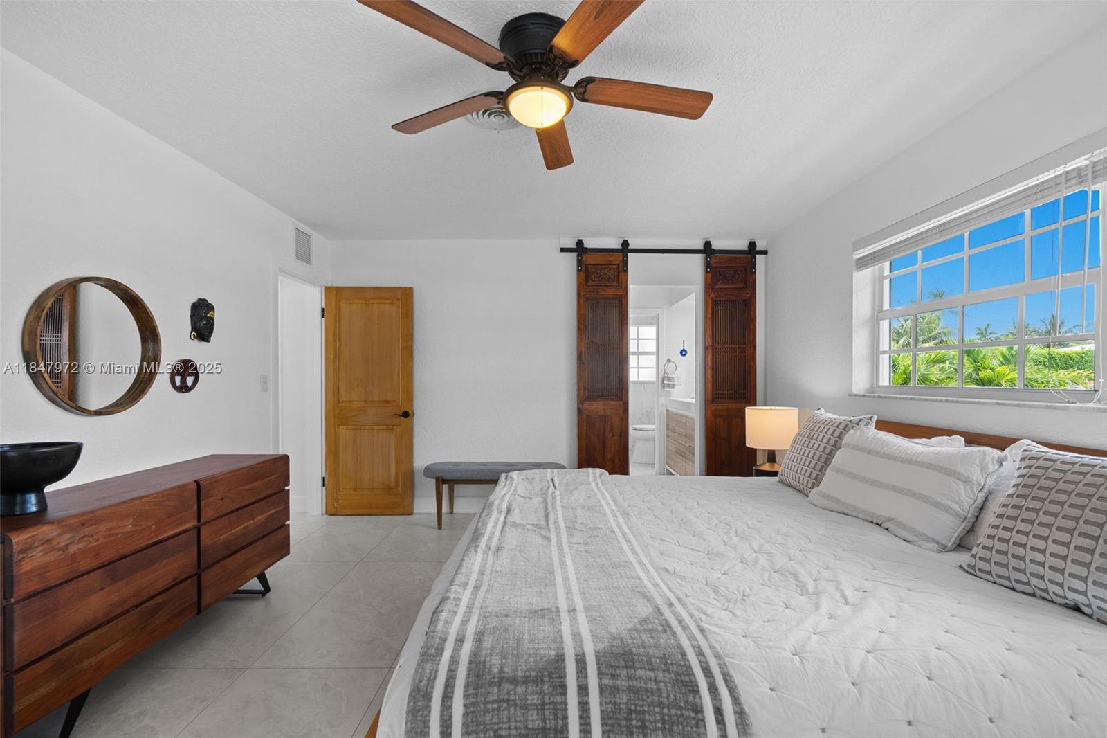 2681 Northeast 9th Court Pompano Beach, FL 33062 - Photo 23 of 58 a bedroom with a bed and a chandelier