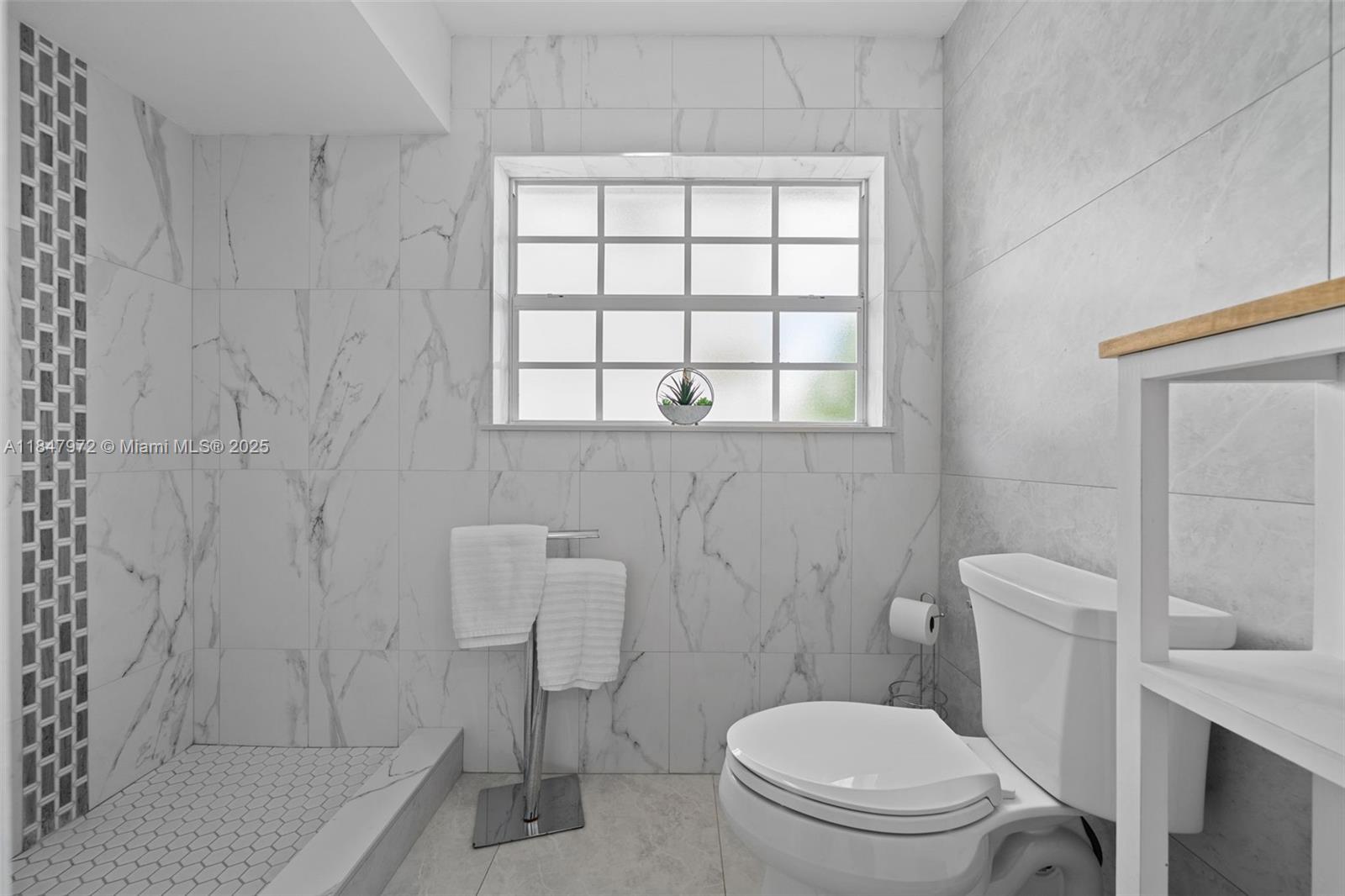 2681 Northeast 9th Court Pompano Beach, FL 33062 - Photo 26 of 58 a white toilet sitting next to a bathroom sink and vanity