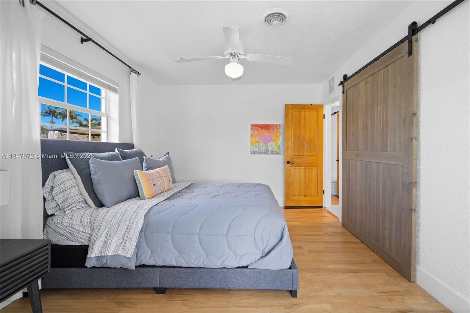 2681 Northeast 9th Court Pompano Beach, FL 33062 - Photo 28 of 58 a bedroom with a bed and a window