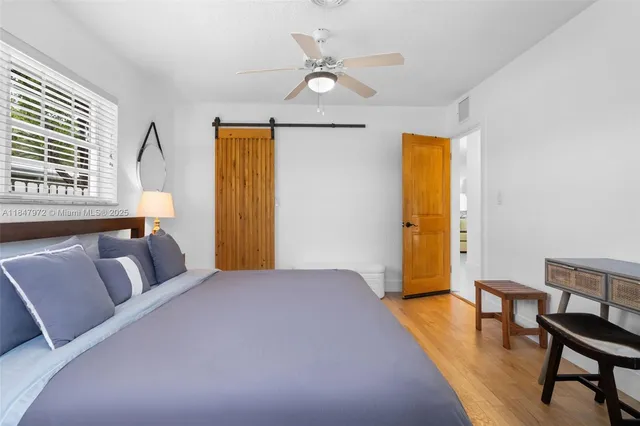 a bathroom with a granite countertop sink a mirror and shower
