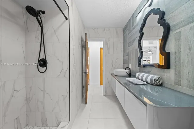 a view of a patio with table and chairs potted plants with floor to ceiling window and potted plants