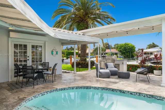 a view of a swimming pool with a patio and a garden