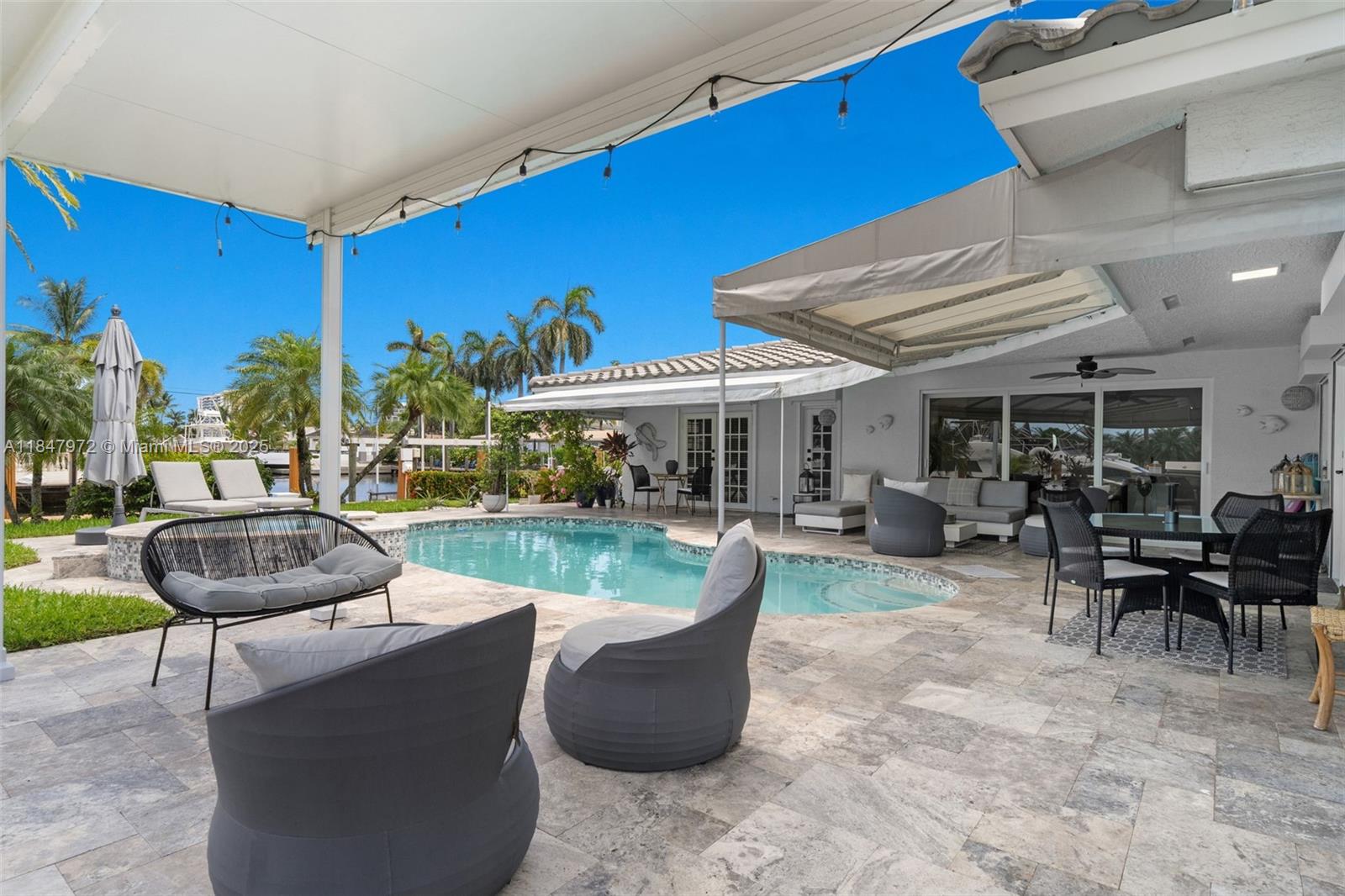 2681 Northeast 9th Court Pompano Beach, FL 33062 - Photo 40 of 58 a view of a patio with couches chairs and a fire pit