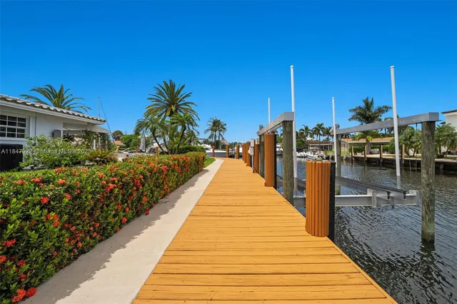 an aerial view of a house with a lake