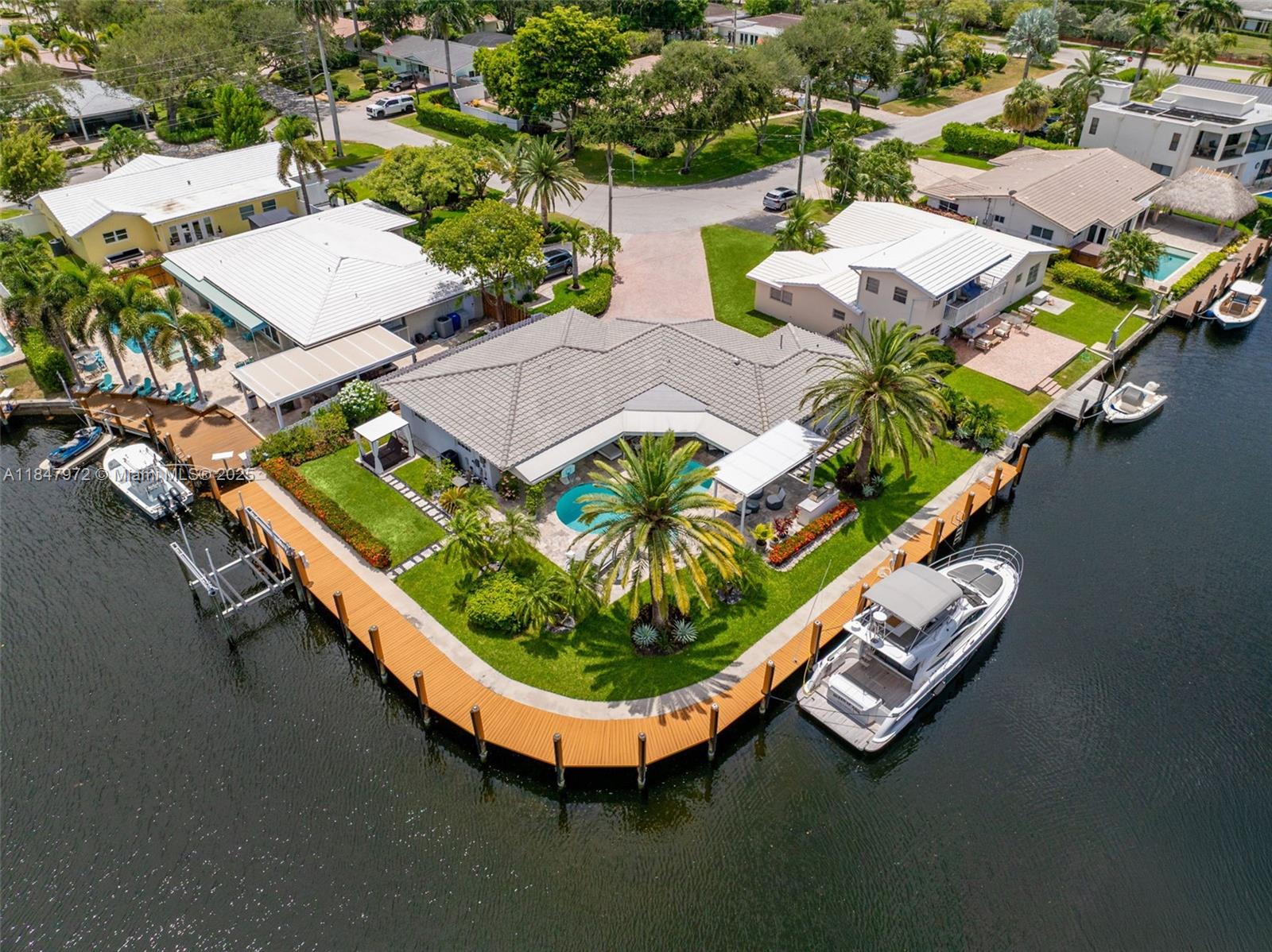 2681 Northeast 9th Court Pompano Beach, FL 33062 - Photo 50 of 58 an aerial view of a house with swimming pool and outdoor seating