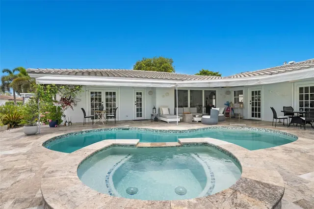 a view of a house with swimming pool and porch