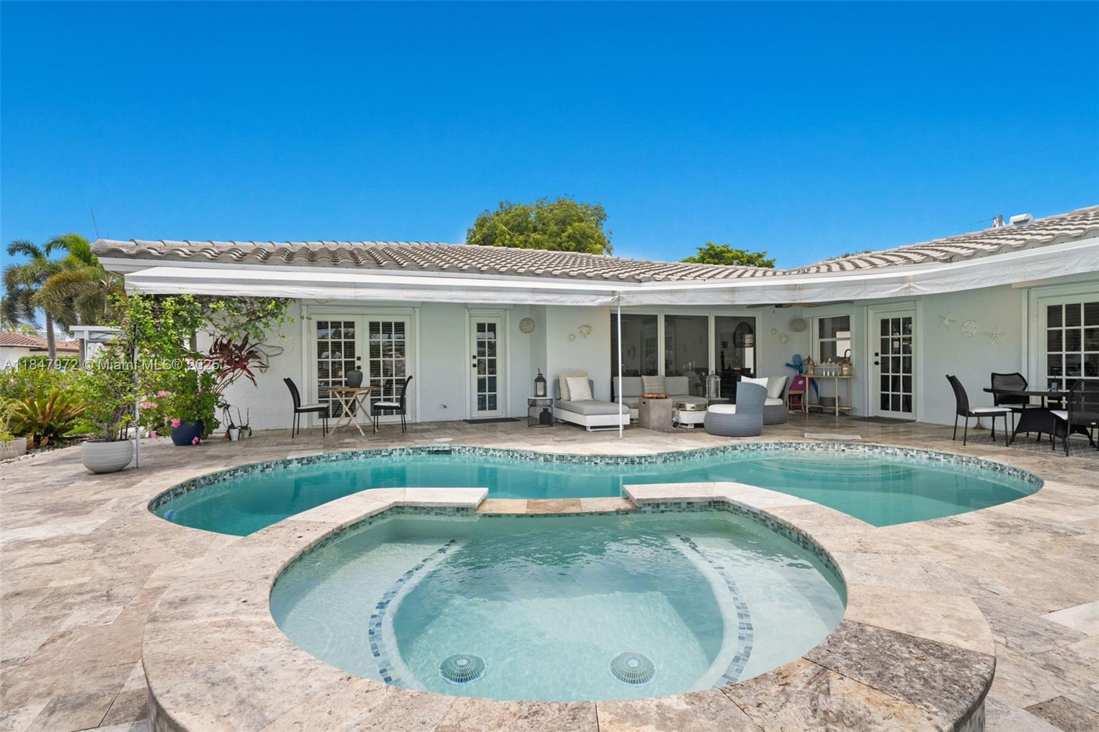 2681 Northeast 9th Court Pompano Beach, FL 33062 - Photo 5 of 58 a view of a house with swimming pool and porch