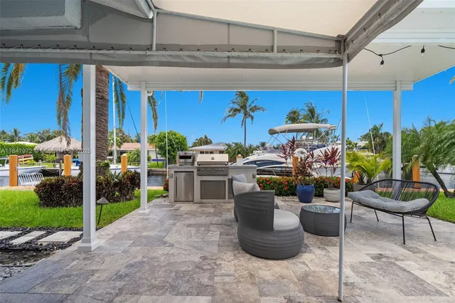 a living room with furniture a rug and potted plants