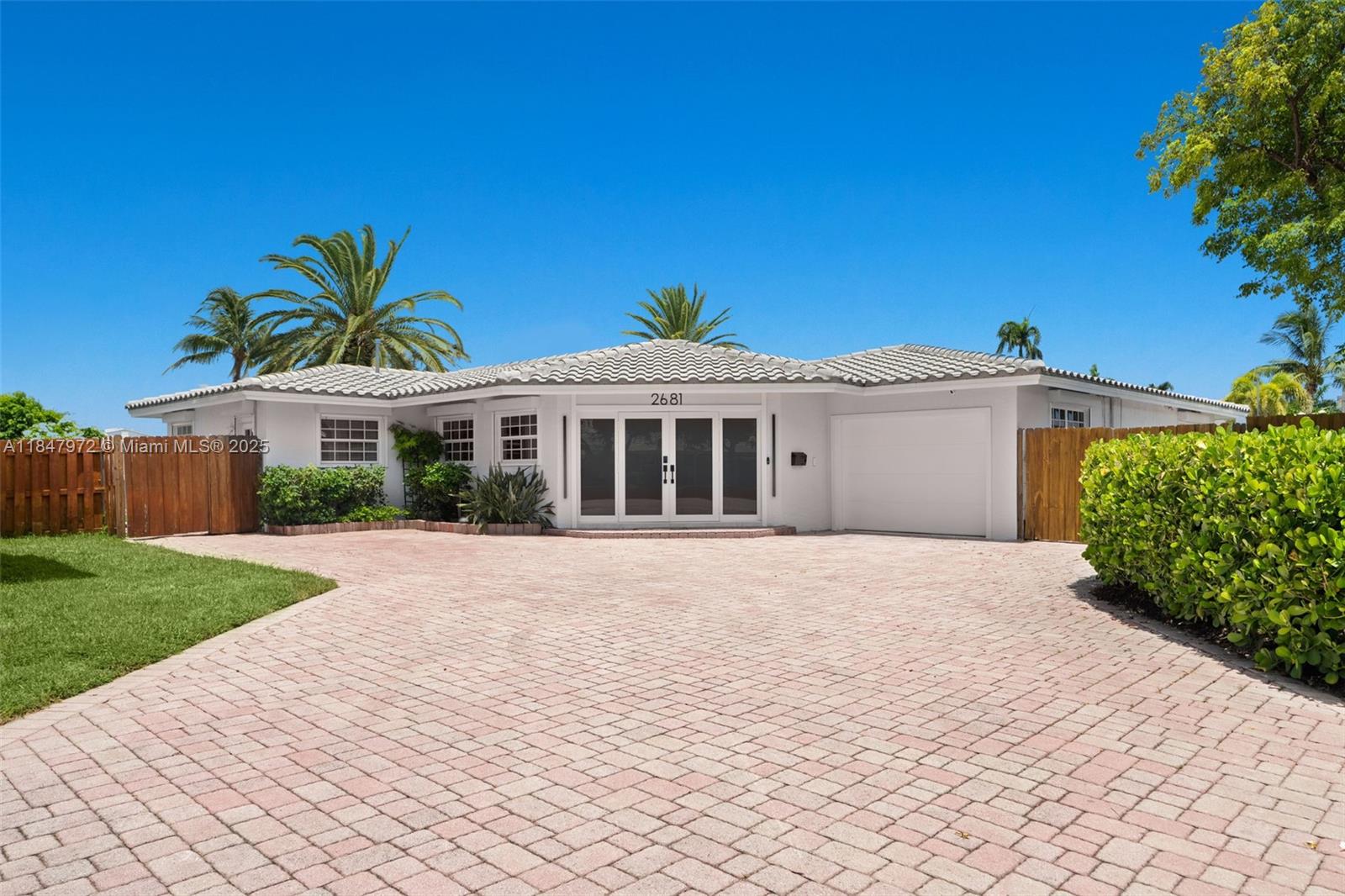 2681 Northeast 9th Court Pompano Beach, FL 33062 - Photo 9 of 58 a front view of a house with a garden