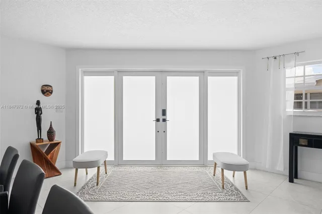 a view of a livingroom with lounge chair and a window