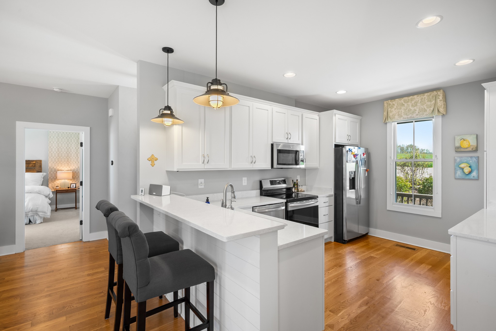 369 Fanning Bend Drive Winchester, TN 37398 - Photo 14 of 54 a kitchen with stainless steel appliances kitchen island granite countertop a refrigerator a stove a sink a dining table and chairs with wooden floor