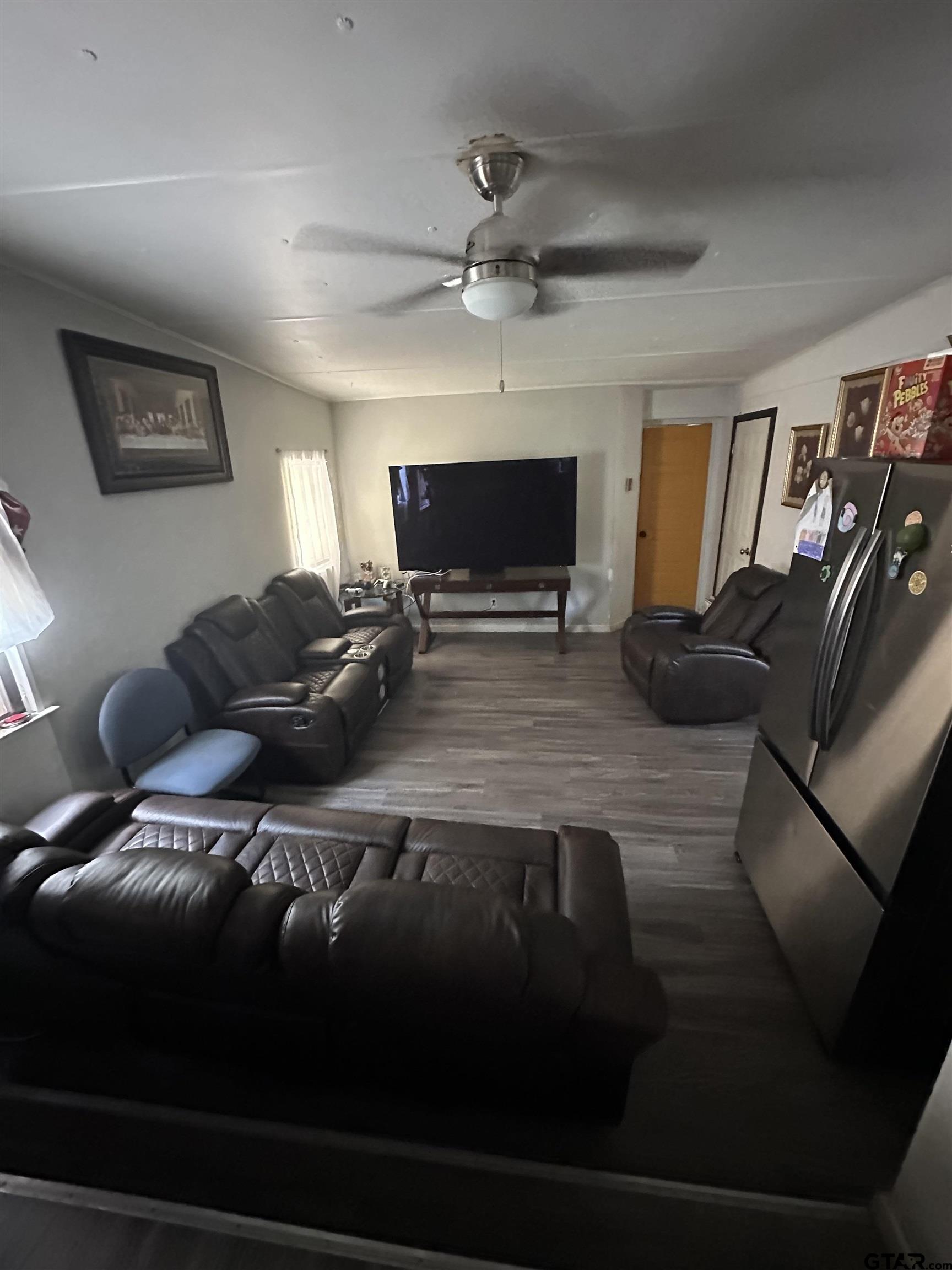 22530 Trailwood Road Flint, TX 75762 - Photo 3 of 8 a living room with furniture and a flat screen tv