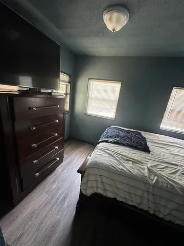 a bedroom with a bed and a television