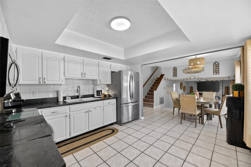 6609 Jennifer Drive Temple Terrace, FL 33617 - Photo 16 of 49 a kitchen with stainless steel appliances granite countertop a refrigerator and a stove top oven