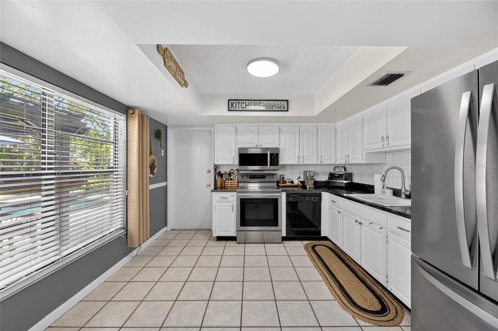 6609 Jennifer Drive Temple Terrace, FL 33617 - Photo 17 of 49 a kitchen with stainless steel appliances a refrigerator sink and stove top oven