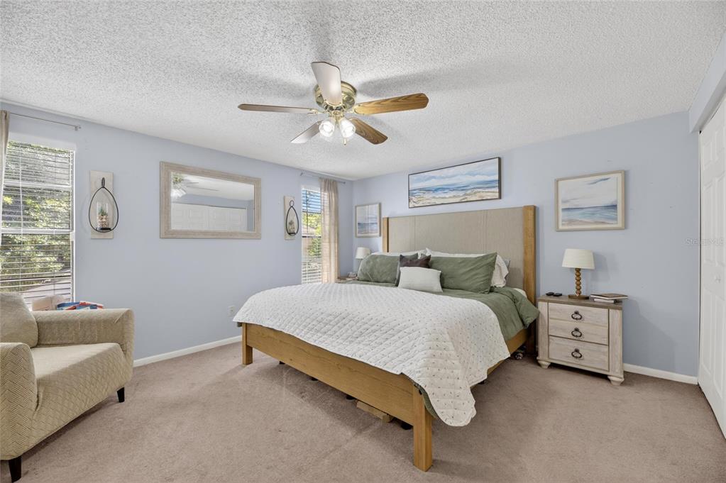 6609 Jennifer Drive Temple Terrace, FL 33617 - Photo 20 of 49 a spacious bedroom with a bed a couch and a window