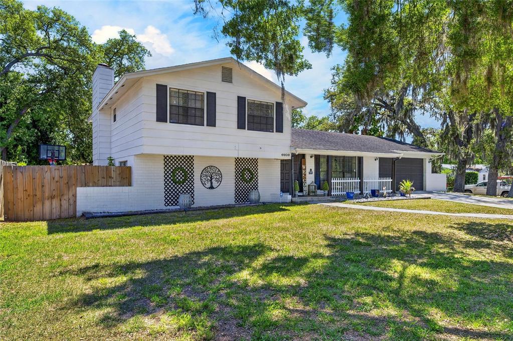 6609 Jennifer Drive Temple Terrace, FL 33617 - Photo 2 of 49 a front view of house with yard and seating area