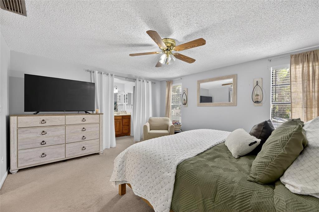 6609 Jennifer Drive Temple Terrace, FL 33617 - Photo 23 of 49 a bedroom with a bed and a flat screen tv