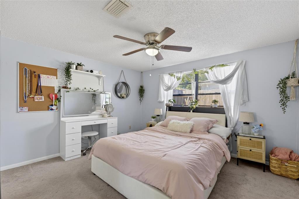 6609 Jennifer Drive Temple Terrace, FL 33617 - Photo 30 of 49 a bedroom with a bed and a chandelier