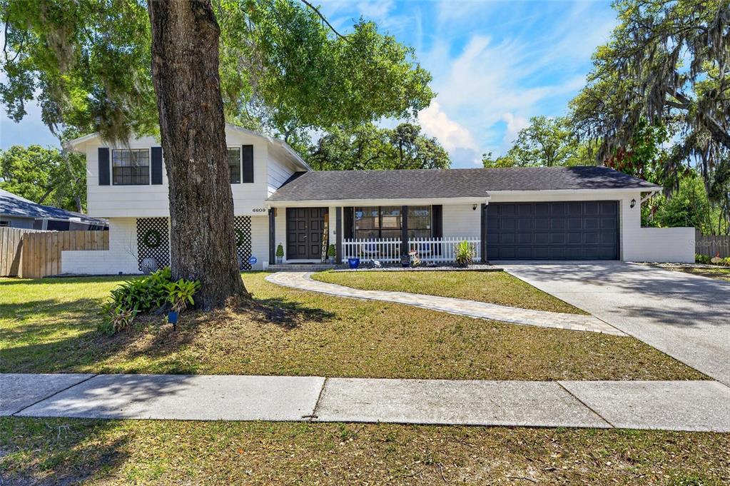 6609 Jennifer Drive Temple Terrace, FL 33617 - Photo 3 of 49 a house with swimming pool in front of it