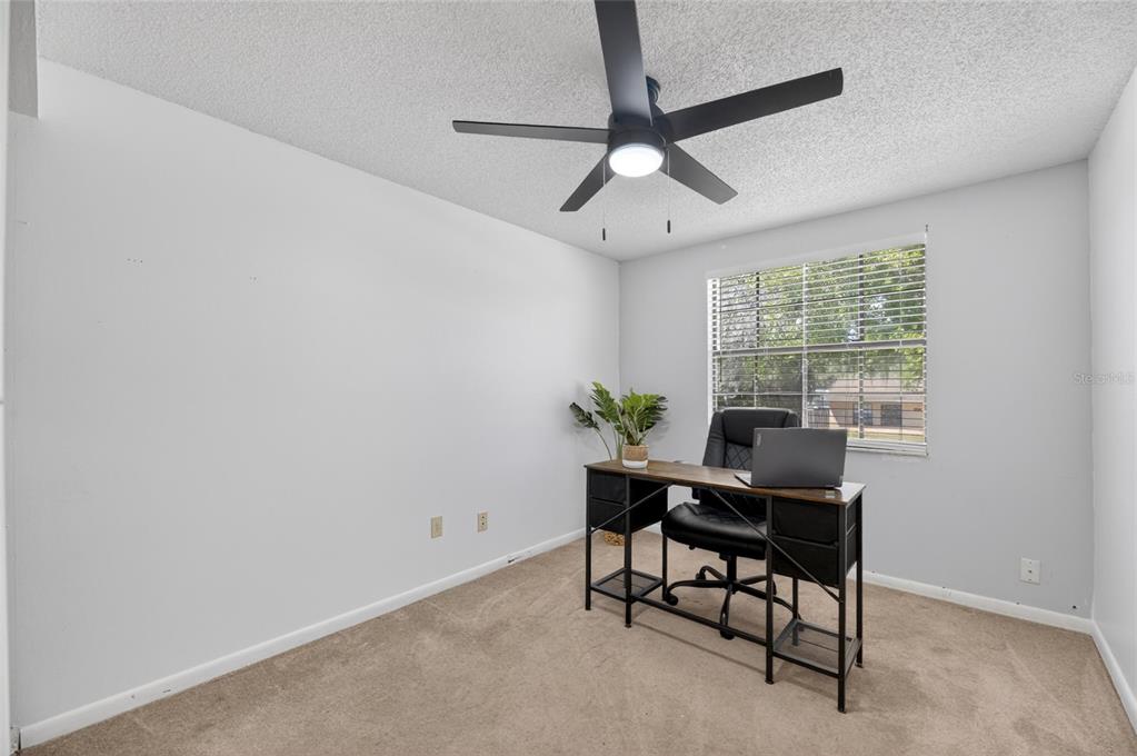 6609 Jennifer Drive Temple Terrace, FL 33617 - Photo 32 of 49 a view of a workspace with furniture and a window