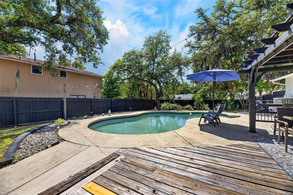 6609 Jennifer Drive Temple Terrace, FL 33617 - Photo 39 of 49 a view of a backyard with sitting area and furniture