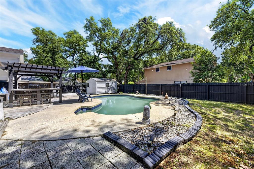 6609 Jennifer Drive Temple Terrace, FL 33617 - Photo 40 of 49 a view of a backyard with a patio