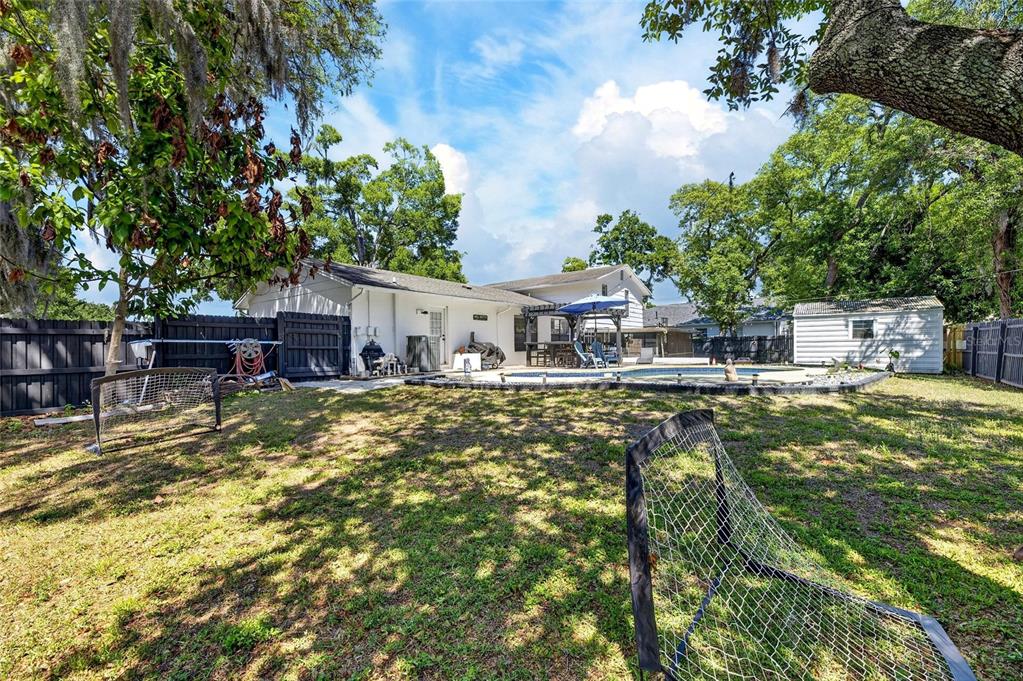 6609 Jennifer Drive Temple Terrace, FL 33617 - Photo 42 of 49 a view of house with swimming pool outdoor seating