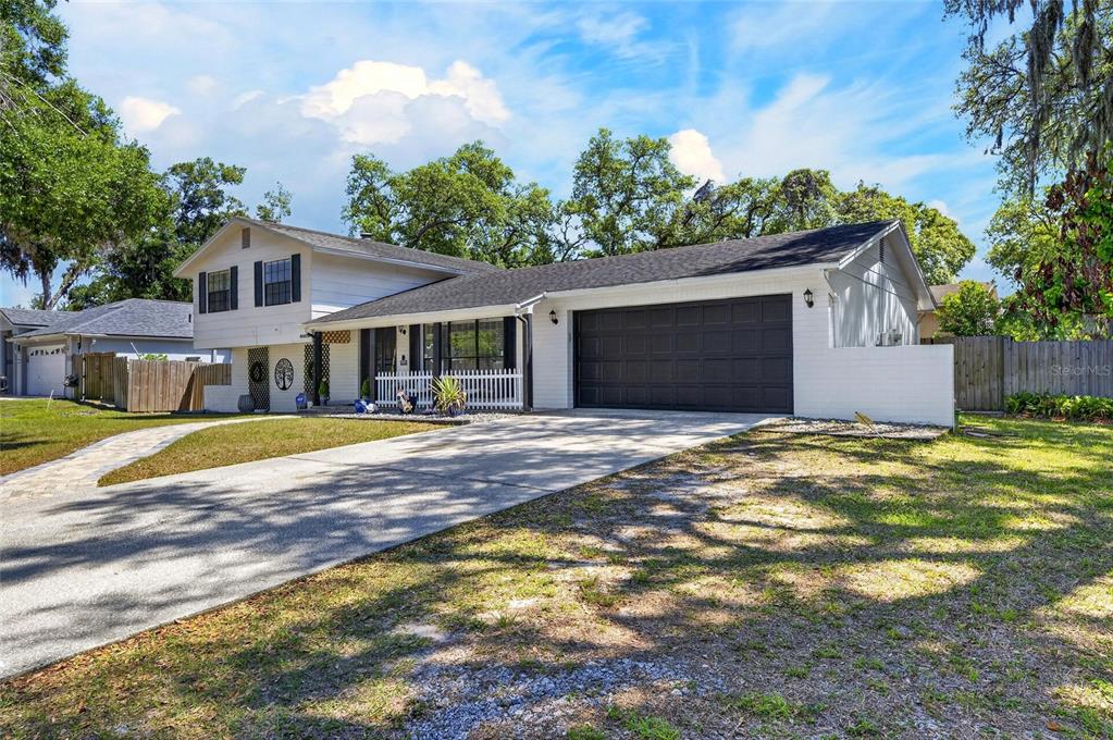6609 Jennifer Drive Temple Terrace, FL 33617 - Photo 6 of 49 a front view of a house with a yard
