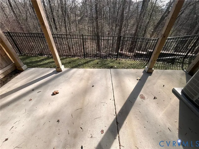 an empty room with a window and a ceiling fan