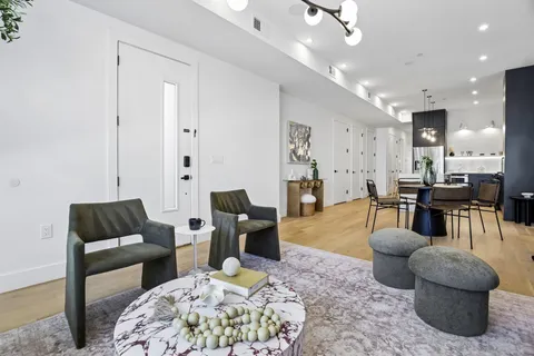 a living room with furniture and a dining table