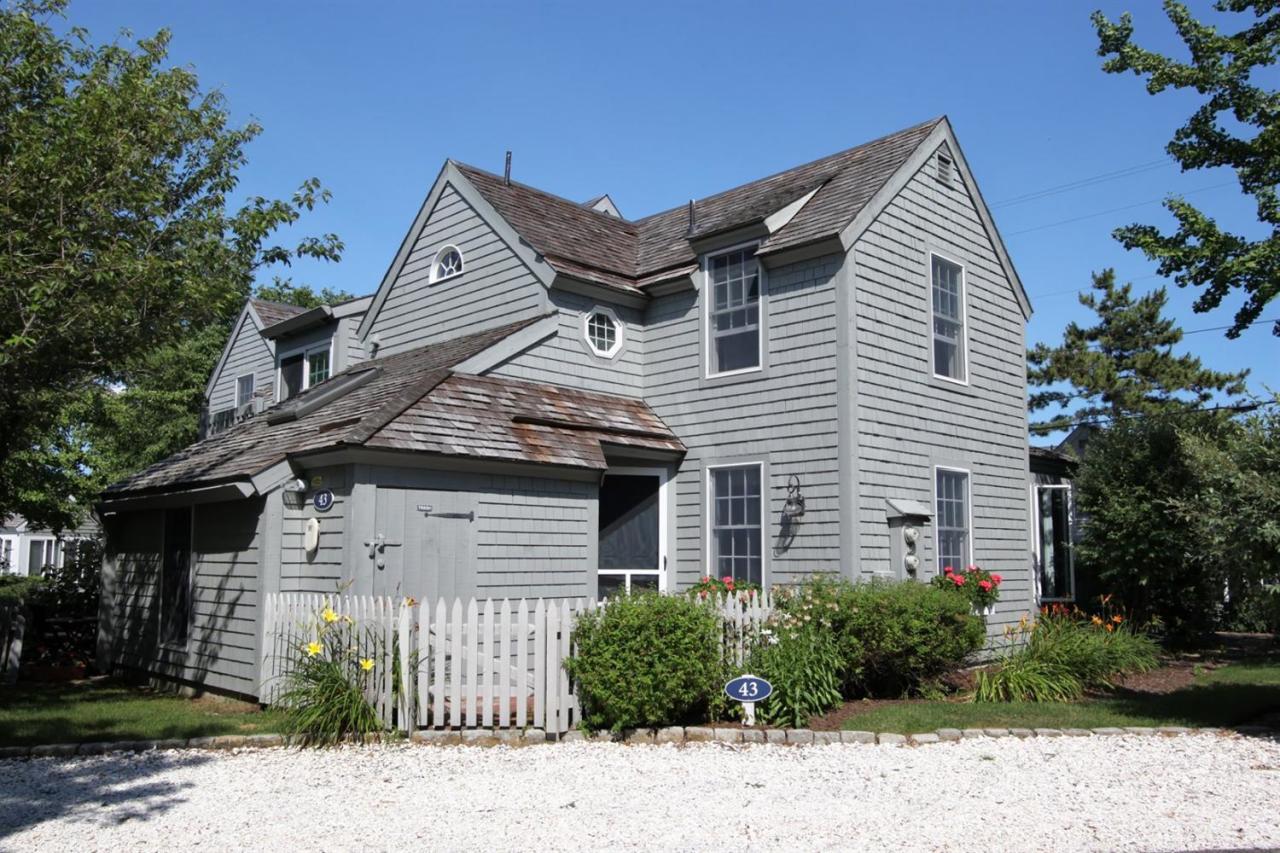 43 Brant Rock Road, Unit 43 Mashpee, MA 02649 - Photo 3 of 16 a front view of a house with a garden