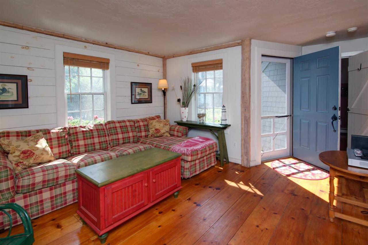 43 Brant Rock Road, Unit 43 Mashpee, MA 02649 - Photo 4 of 16 a bedroom with a bed and a dresser with wooden floor
