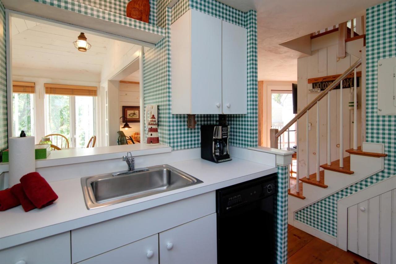 43 Brant Rock Road, Unit 43 Mashpee, MA 02649 - Photo 8 of 16 a kitchen with a sink and a refrigerator