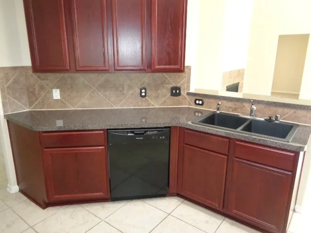 a kitchen with a sink and cabinets
