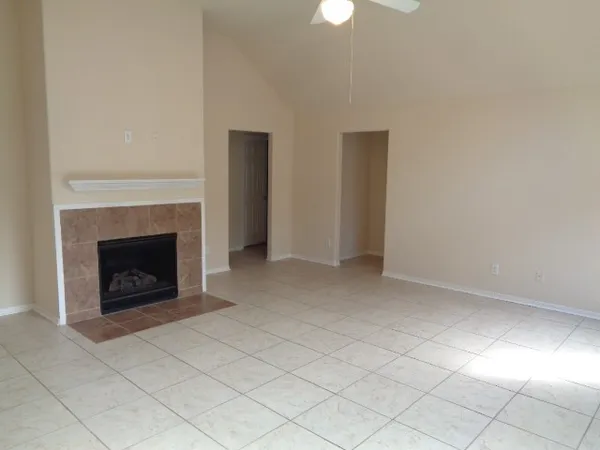a view of an empty room with a fireplace