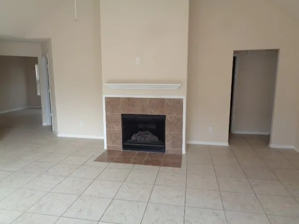 a view of an empty room with a fireplace