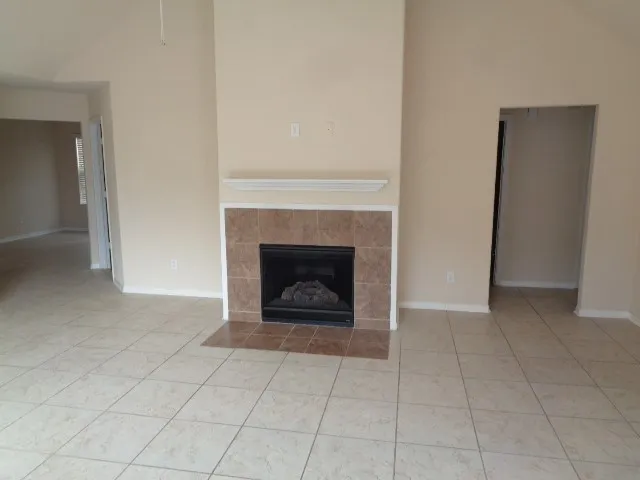 a view of an empty room with a fireplace