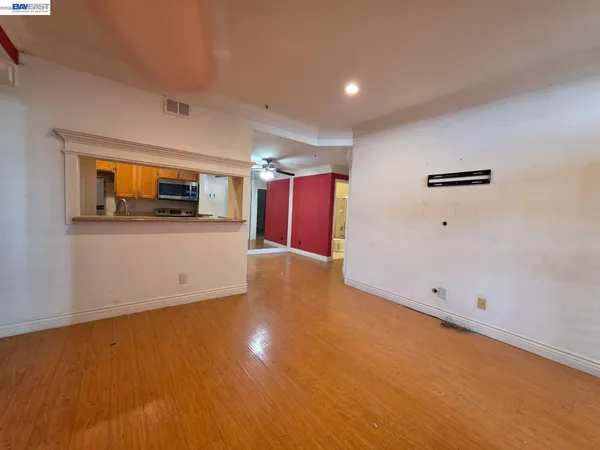 a view of a room with wooden floor and window