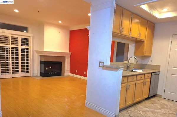 a view of an empty room with a fireplace and a window