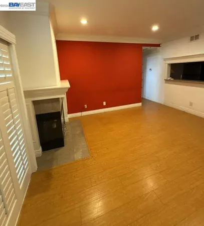 a view of an empty room with a fireplace