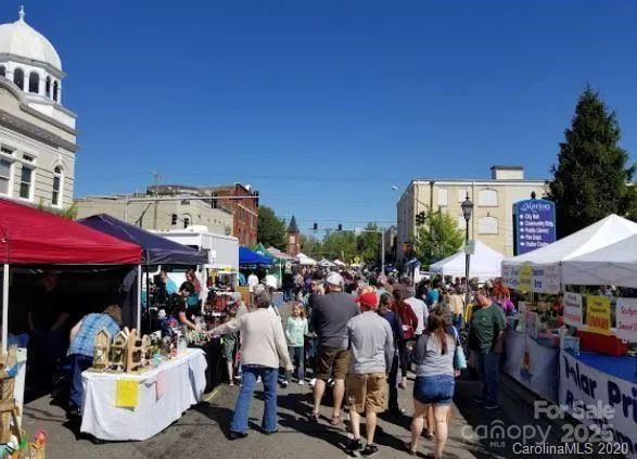 a group of people sitting in front of retail shop
