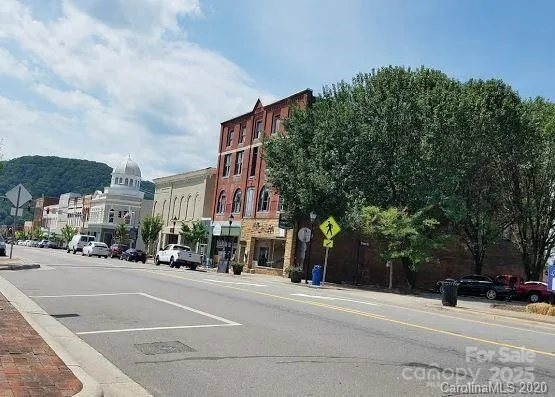 a view of a street with a building in the background