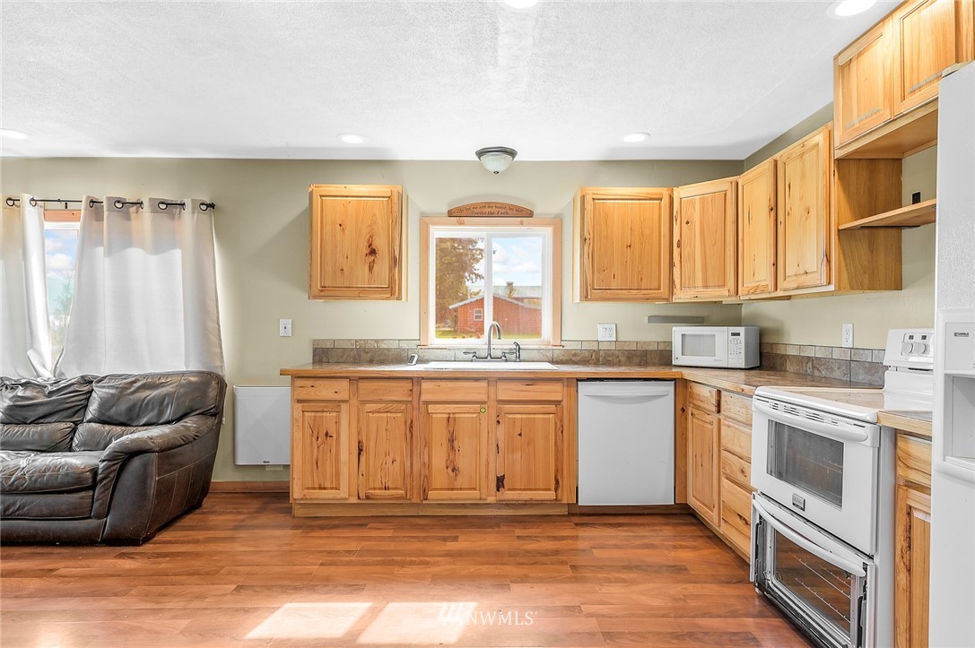 2890 East Badger Road Everson, WA 98247 - Photo 21 of 38 a spacious bathroom with a granite countertop tub sink and mirror