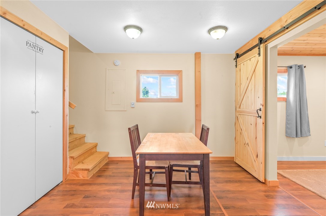 2890 East Badger Road Everson, WA 98247 - Photo 22 of 38 a view of a dining room with furniture and wooden floor