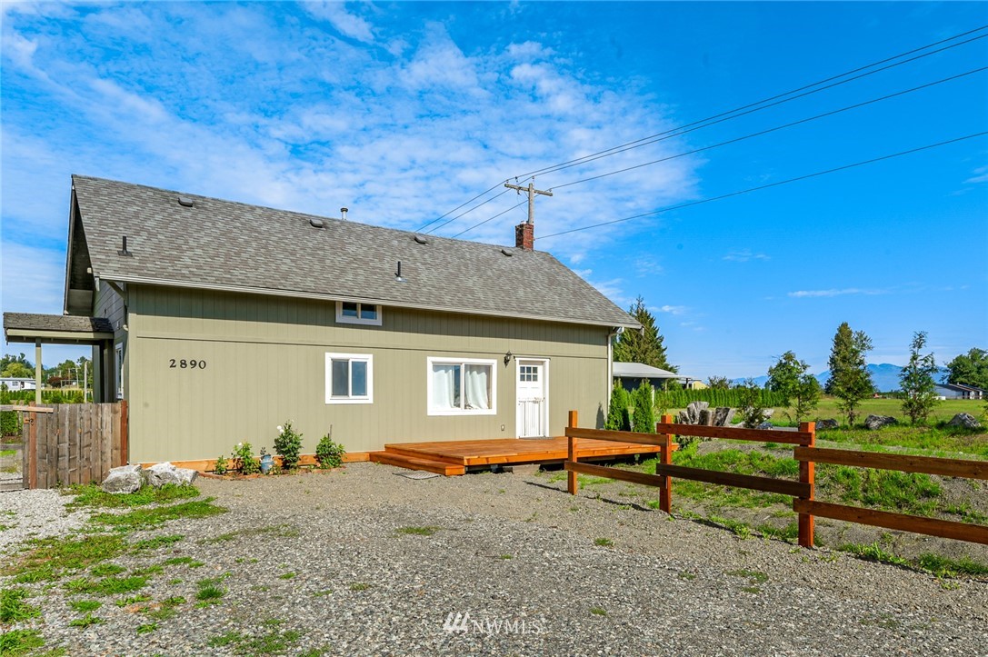 2890 East Badger Road Everson, WA 98247 - Photo 5 of 38 a backyard of a house with barbeque oven table and chairs
