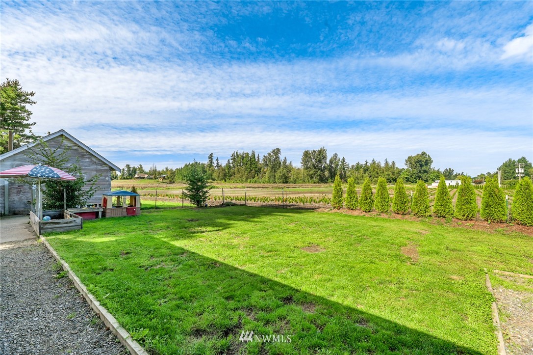 2890 East Badger Road Everson, WA 98247 - Photo 7 of 38 a view of a big yard with plants and large trees