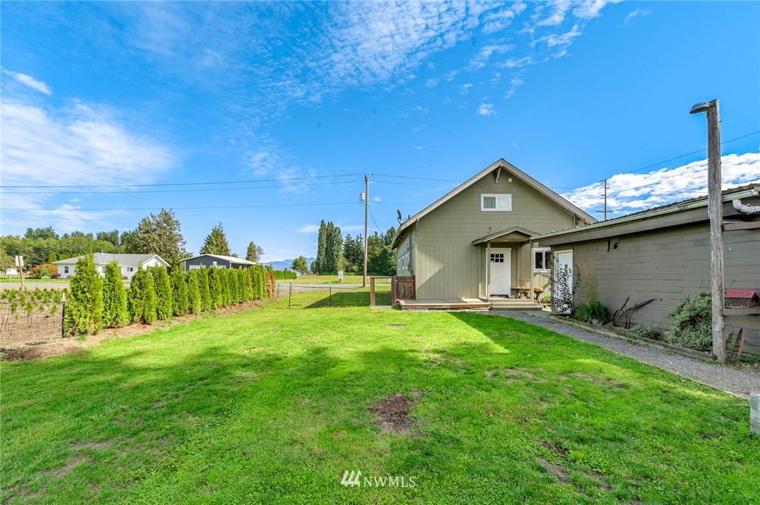 2890 East Badger Road Everson, WA 98247 - Photo 10 of 38 a view of a house with a yard and sitting area