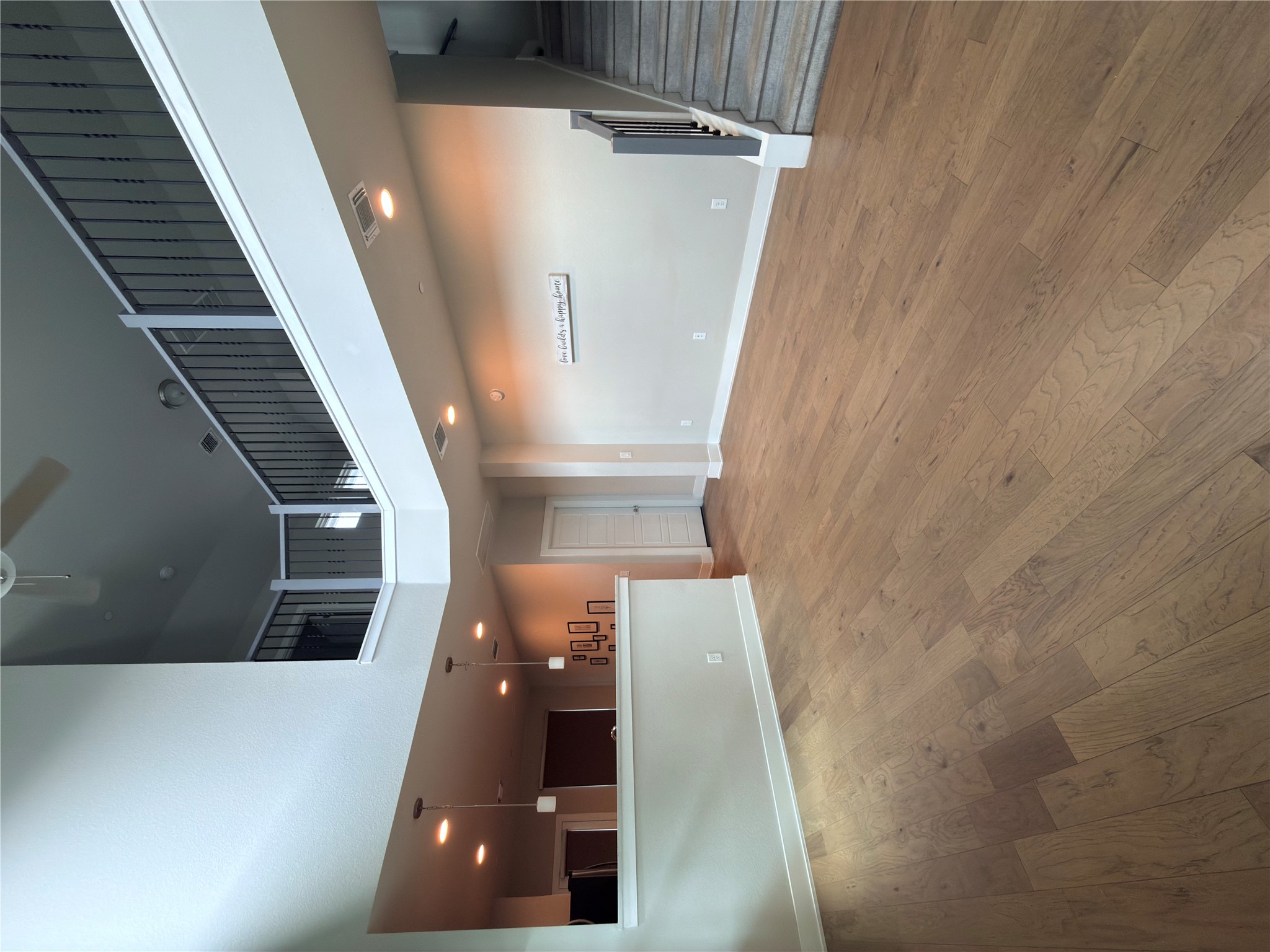 11216 Gadsen Lane Austin, TX 78754 - Photo 32 of 36 An airy living space features soaring ceilings and natural light-toned hardwood flooring.